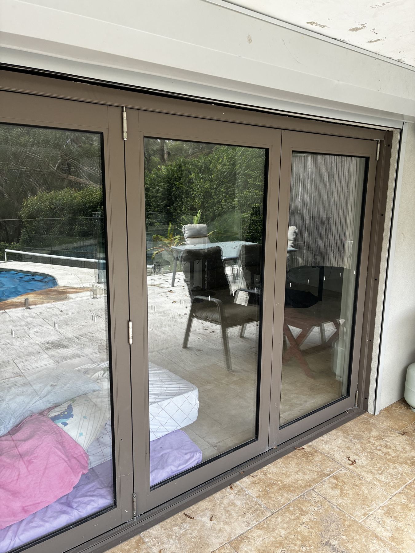 Clean bi-fold doors facing a pool