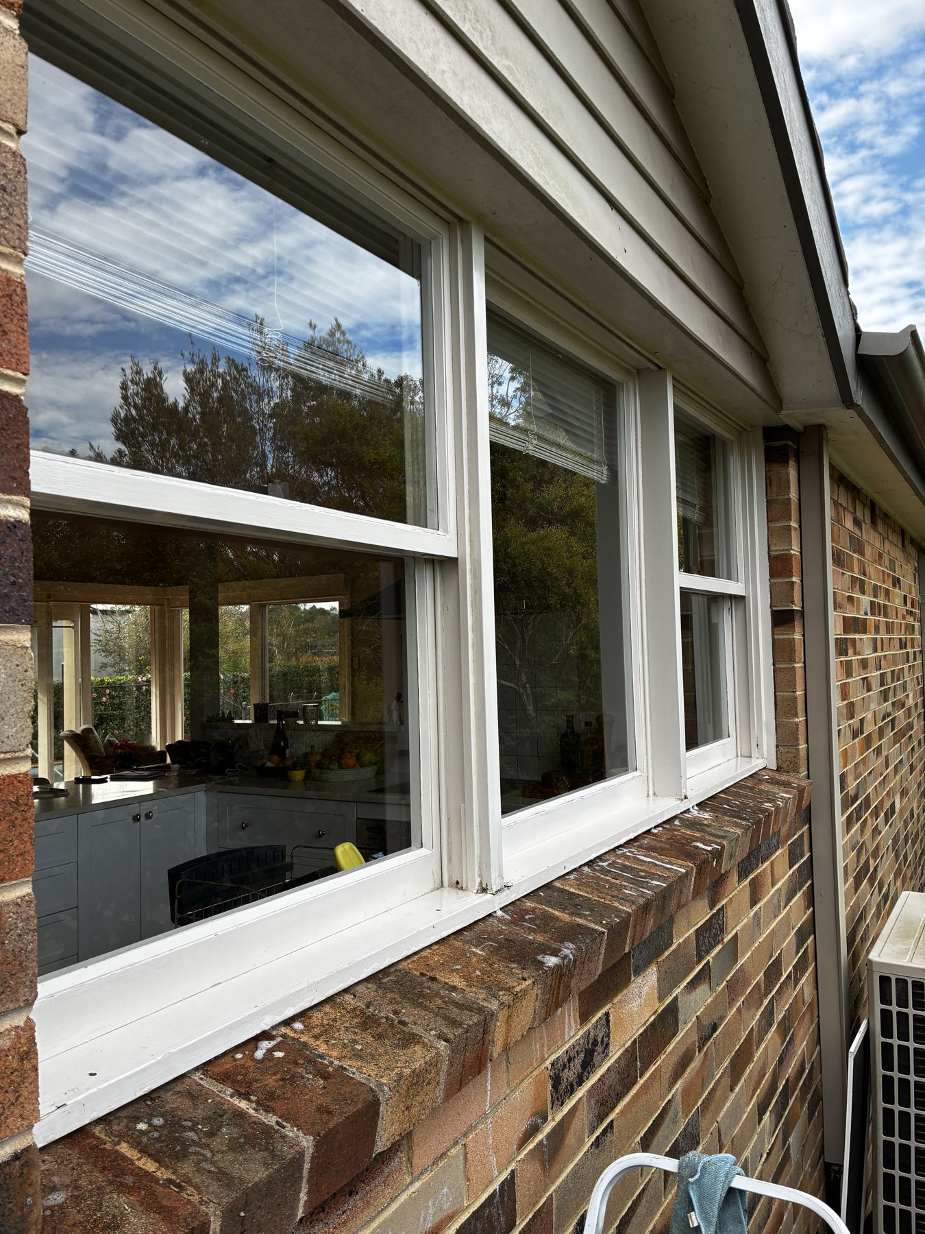 Clean double-hung windows on a brick home