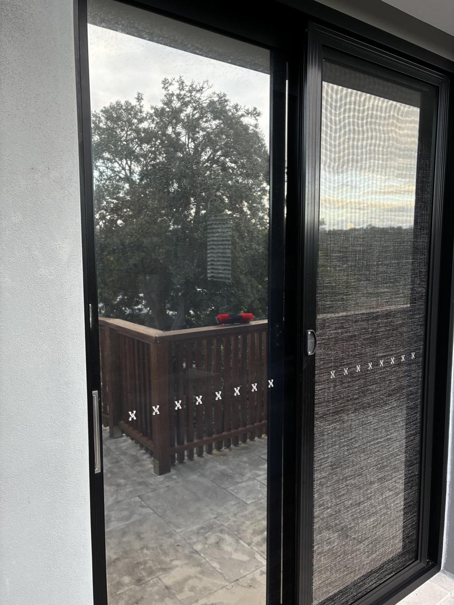 Clean black sliding doors onto a deck