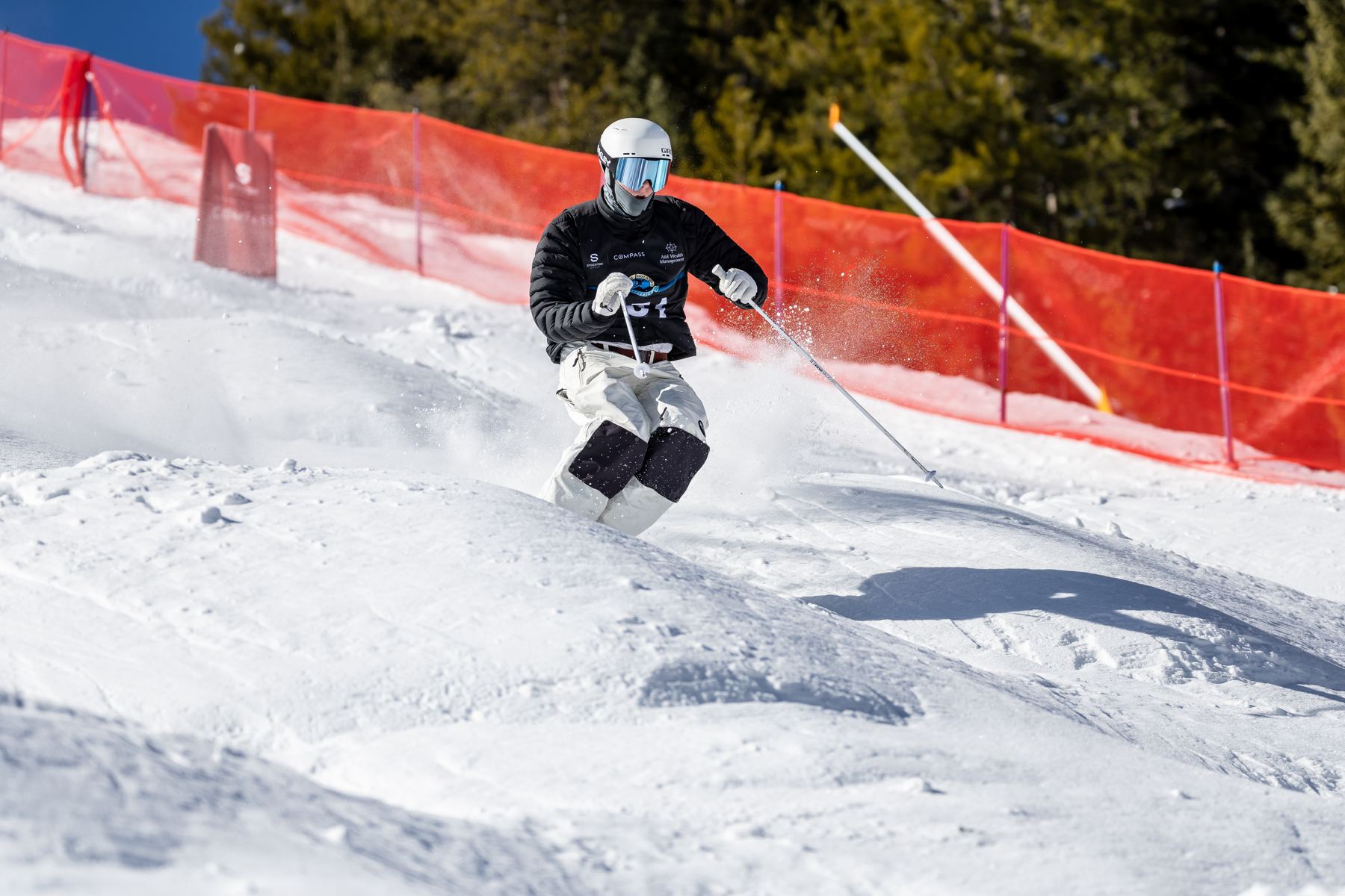 Hugh skiing through moguls